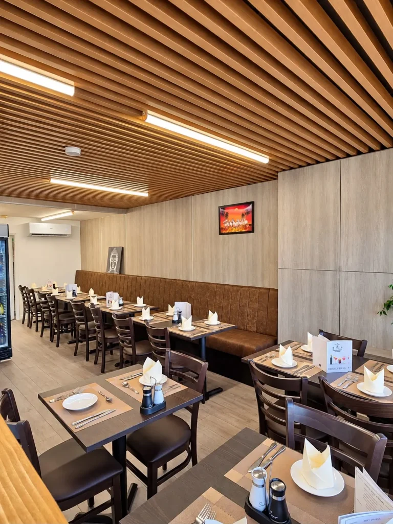 The Namaste Gurkha dining room in Birchwood, Lincoln, with a timber-slat ceiling and tables set for dinner